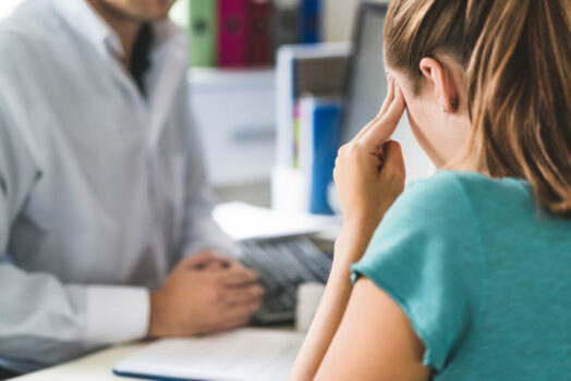 Woman consulting chiropractic neurologist about post-covid symptoms